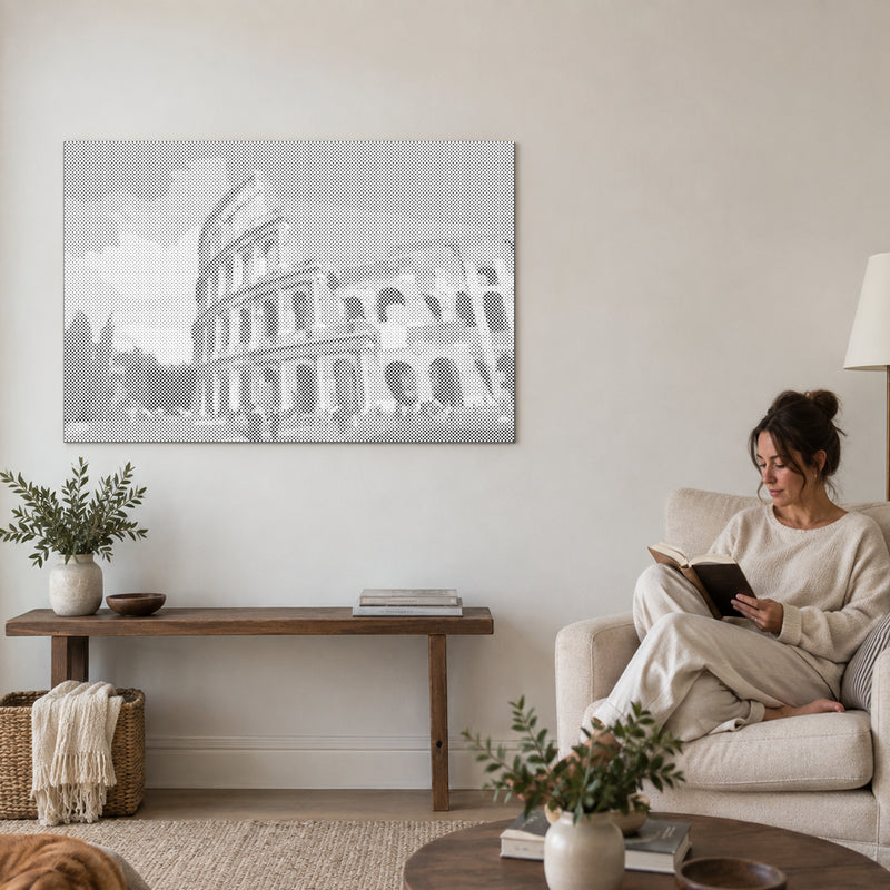 Dot-painting canvas “Colosseum Rome”, on a living-room wall with a person reading in an armchair nearby.