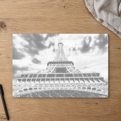 Dot-painting canvas “Eiffel Tower”, seen from above on a worktable in soft daylight.