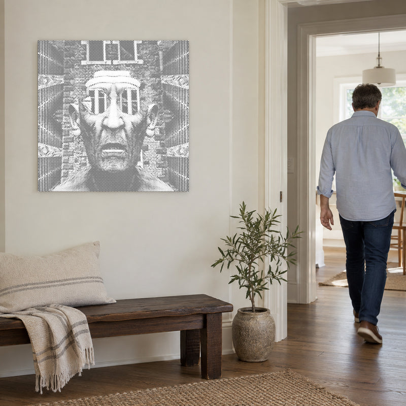 Dot-painting canvas “Fearsome Man”, on a light wall with a person walking through the doorway nearby.