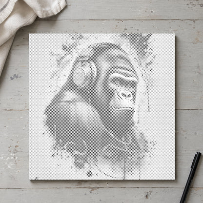 Dot-painting canvas “Gorilla with Headphones”, seen from above on a worktable in soft daylight.