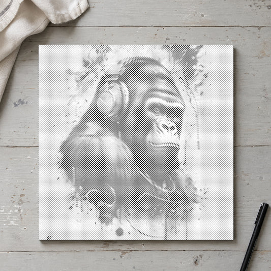 Dot-painting canvas “Gorilla with Headphones”, seen from above on a worktable in soft daylight.