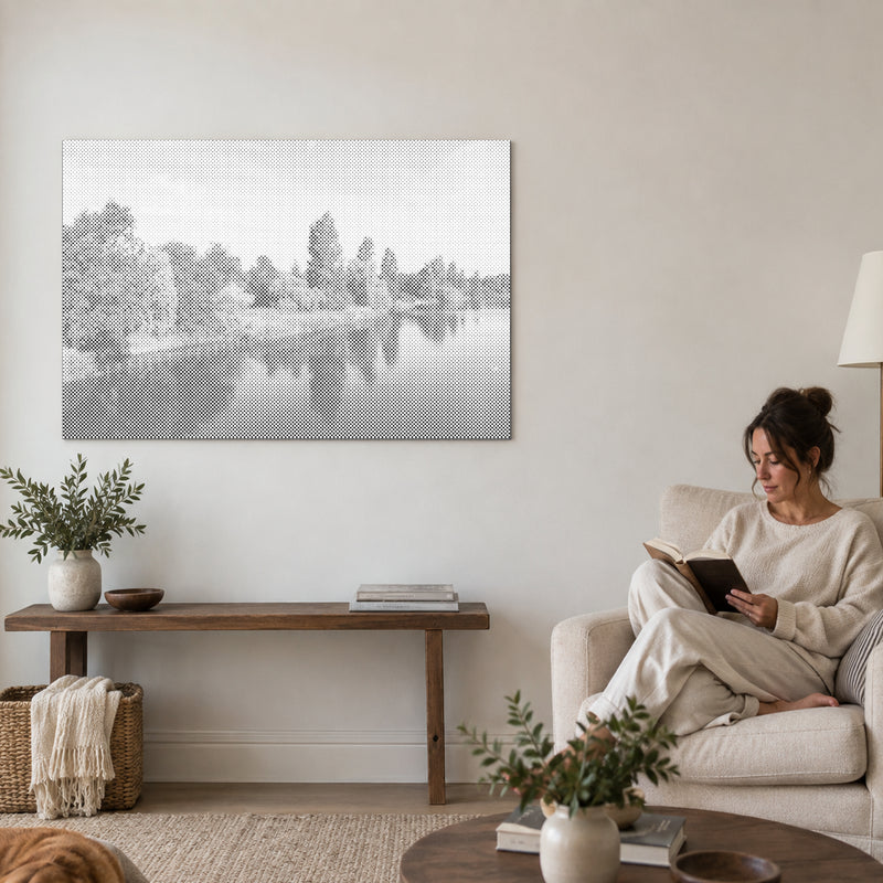 Dot-painting canvas “Hyde Park London”, on a living-room wall with a person reading in an armchair nearby.