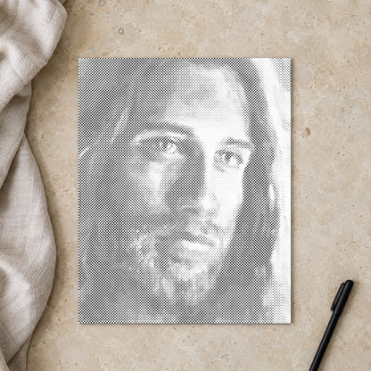 Dot-painting canvas “Jesus Christ”, seen from above on a worktable in soft daylight.