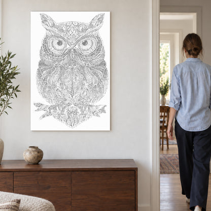 Dot-painting canvas “Owl Mandala”, on a light wall with a person walking through the doorway nearby.