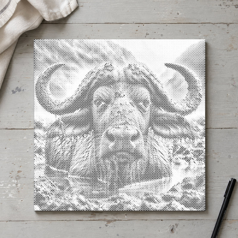 Dot-painting canvas “Water Buffalo”, seen from above on a worktable in soft daylight.