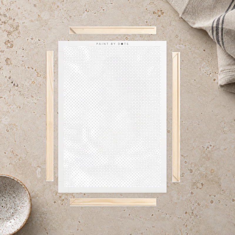 Wooden Frame Kit for Canvas, laid out on a light stone work surface beside a linen cloth.
