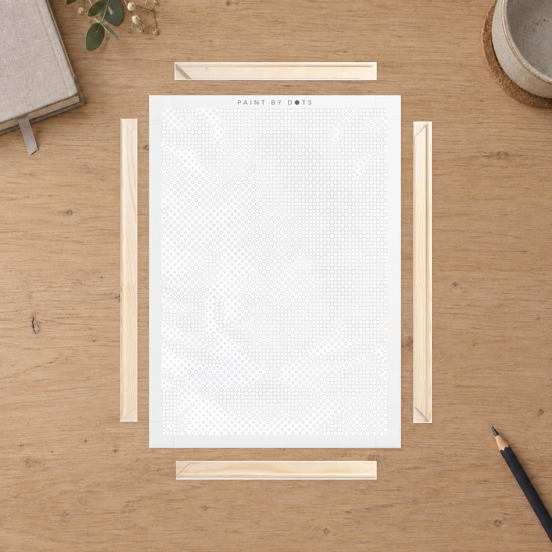 Wooden Frame Kit for Canvas, laid out on a pale oak worktable in natural daylight.